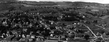 Bird's eye view of town and open fields