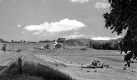 Farmers collecting hay bales