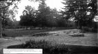 View of front lawn at Oakledge with rock outcropping, Web era