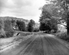 Dirt Road with Farm in Distance