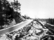 Car on a Dirt road near Railroad Tracks