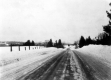 Winter Road with Cleared slopes in distance