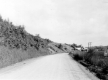 Highway entering town with erosion on steep banks