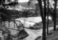 Steel Bridge Over River With Dam