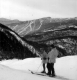 Two skiiers at the top of a mountain