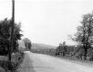 Dirt Road With Pastures and Farm in Distance
