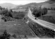 Car On Paved Road with Pastures