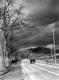 Car Driving Under Stormy Skies