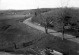 Dirt Road Around a Bend with Wooden Fences