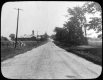 Gravel road by farm