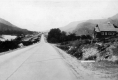 House in Valley, Next to Paved Road
