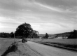 Car on Rural Road with Fields