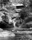 Covered Bridge Over Waterfall