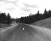 Grassy hill and paved road