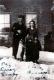 Family in front of brick building