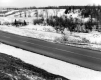 Snow Along Rural Road in Spring