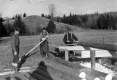 Three Men Boring Through Logs