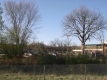 Cars and Commercial Buildings Behind Chainlink Fence