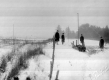 Students Along A Fence in a Meadow with Snow