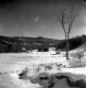 House and Barns Covered with Snow