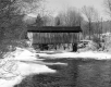 Covered Bridge Over Snow Covered River