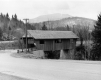 Covered Bridge With Mountains in the Background