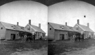 Team of Horses Outside a House