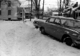 Cars Parked Along Snowy Sidewalk