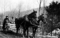 Will S. Monroe and Charlie Morse in a horse drawn carriage