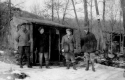 Four men in front of the twin shelters