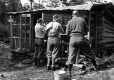 Three men shaving at Cooley Glen Shelter