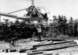 Helicopter delivering cedar logs to inaccessable ares of Mt. Mansfield to be used for building trails