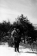 Donald M. Wallace in the snow carrying snowshoes
