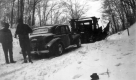 Tractor towing vehicle in the snow