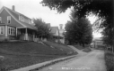 House, hotel, church and mill along dirt road