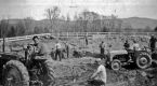 Group of men working with tractors