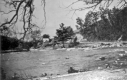 Flood damage to road alongside a river