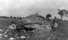 Boy next to boulder of St. Albans foundation