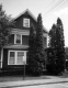 House with large trees near front door