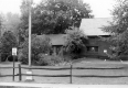 Brick building behind a wooden fence