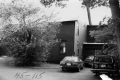 Three automobiles in the driveway of a house