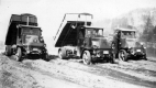 Three dump trucks in the mud