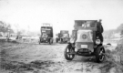 Three work trucks in a clearing