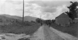 Three Hikers Walking Down Dirt Road