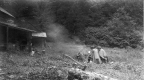 Three Men Sitting Around a Fire