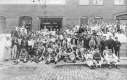 Workers Posing Outside a Brick Building