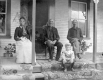 Family Posing for Picture in Front of House