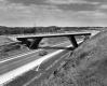Car Driving Beneath Overpass