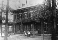 Two women on the Porch of a Brick House