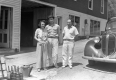 Three People Standing in front of Service Station